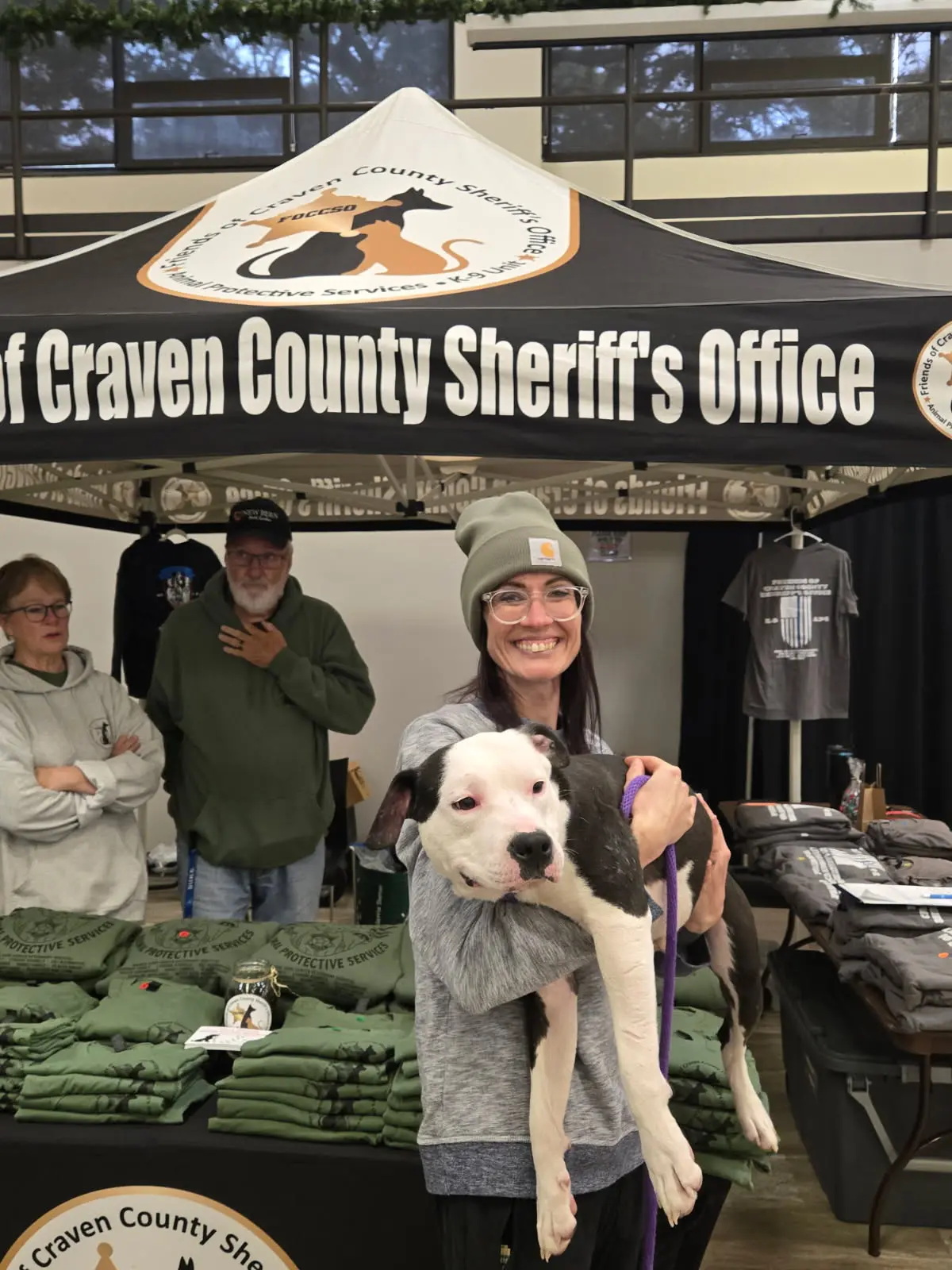 Rescue volunteers with a dog at a community event