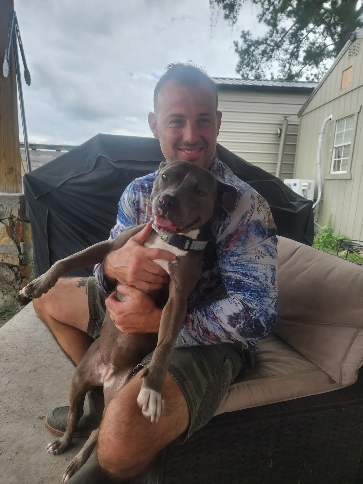 A volunteer holding a young rescue dog